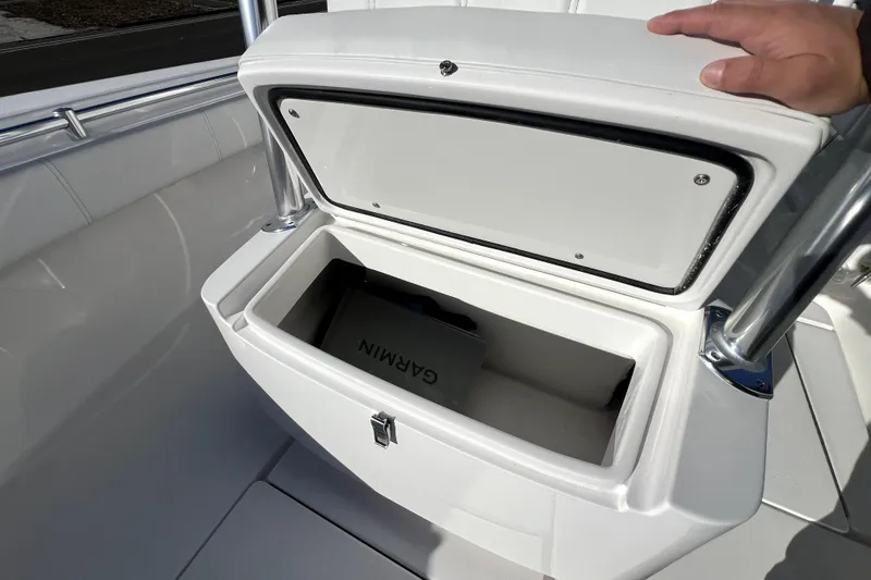 Slide: The Image of Open storage compartment on 2026 Contender 25 Tournament boat with Garmin equipment inside. - 21