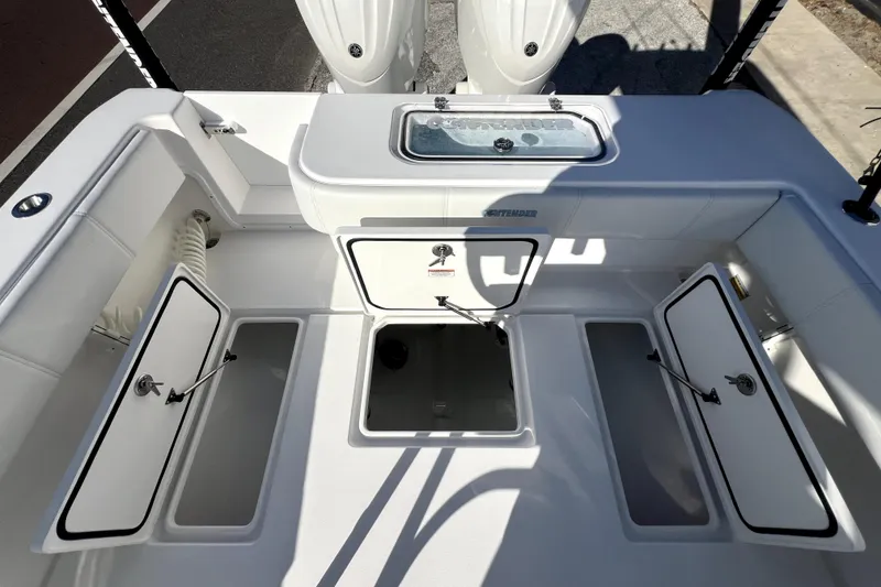 Slide: The Image of 2026 Contender 25 Tournament boat deck with open storage compartments and livewell. - 26