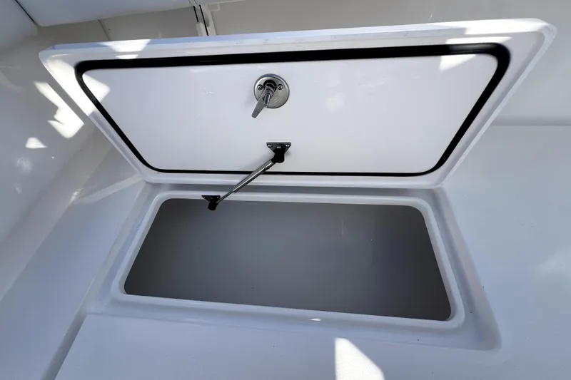 Slide: The Image of Open storage compartment on 2026 Contender 25 Tournament boat. - 27