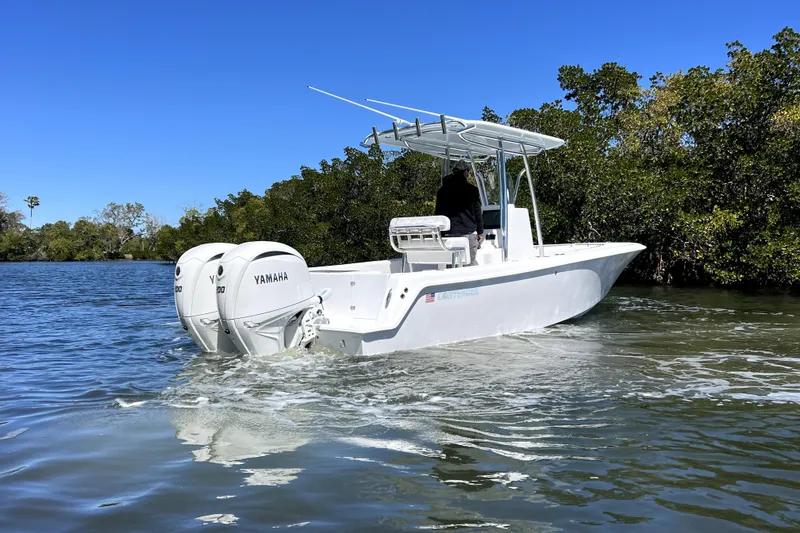 Slide: The Image of 2026 Contender 25 Tournament boat with dual Yamaha engines on a calm waterway. - 3