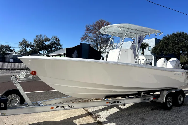 Slide: The Image of 2026 Contender 25 Tournament boat on trailer, parked outdoors under clear blue sky. - 37