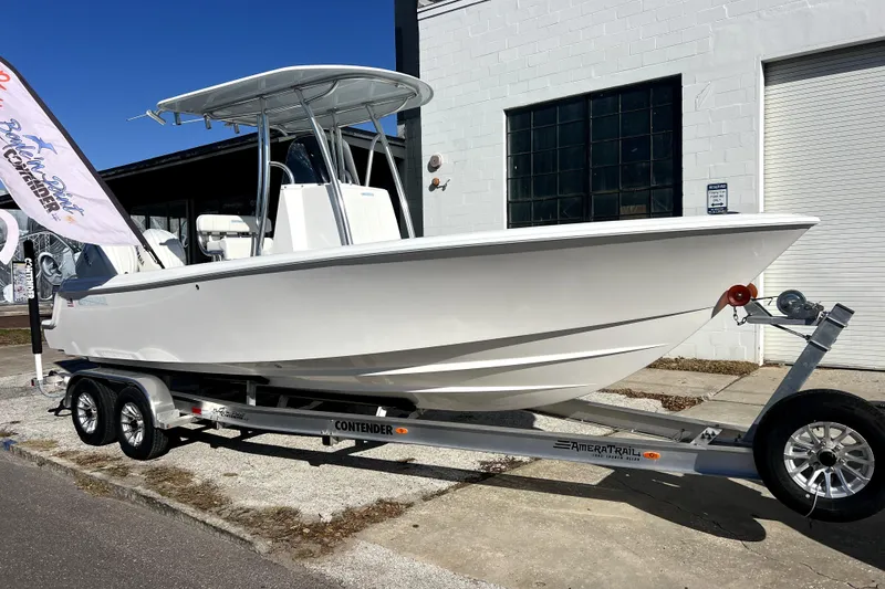 Slide: The Image of 2026 Contender 25 Tournament boat on trailer, parked outside a building. - 38