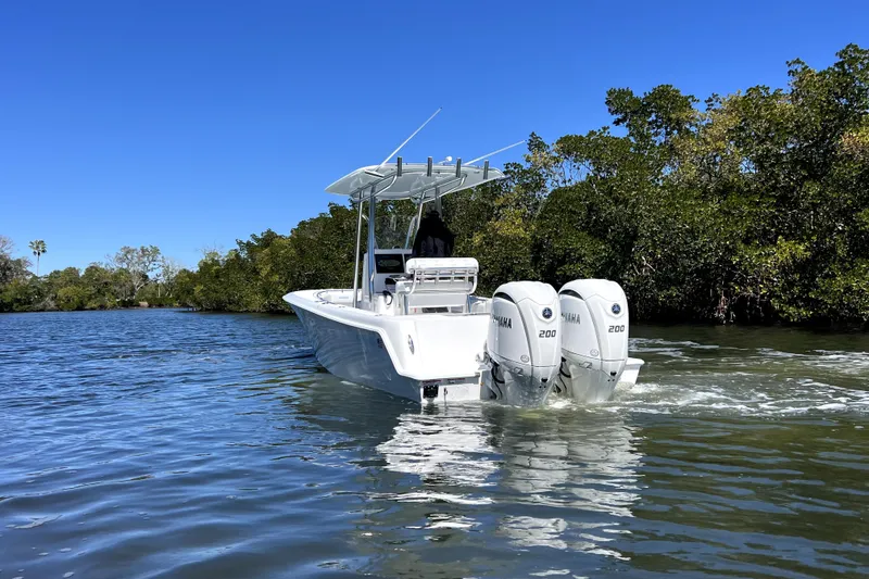 Slide: The Image of 2026 Contender 25 Tournament boat with dual Yamaha engines on a sunny day. - 4