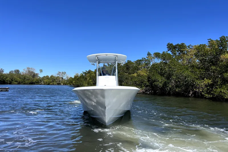 Slide: The Image of 2026 Contender 25 Tournament boat cruising on a sunny day, surrounded by lush greenery. - 5
