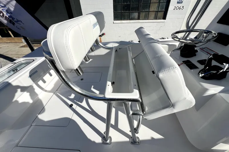 Slide: The Image of 2026 Contender 25 Tournament boat interior with white seating and steering wheel. - 9