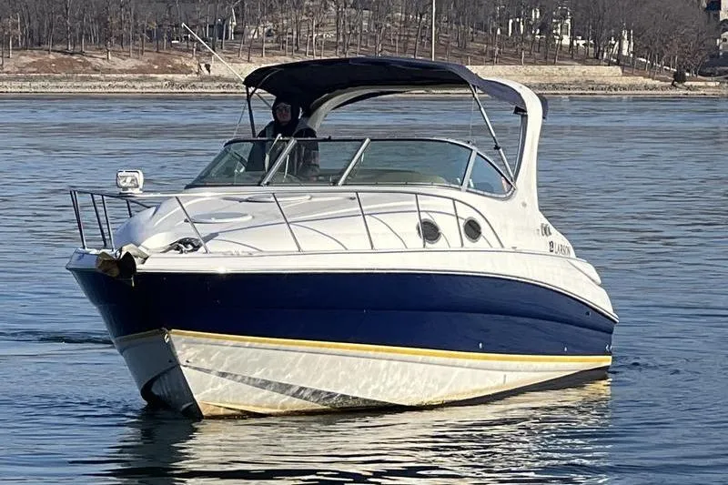 Slide: The Image of 2005 Larson Cabrio 290 boat cruising on calm water. - 3