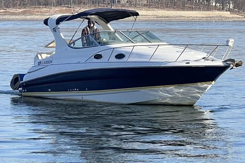 Slide: The Image of 2005 Larson Cabrio 290 boat cruising on calm water. - 8