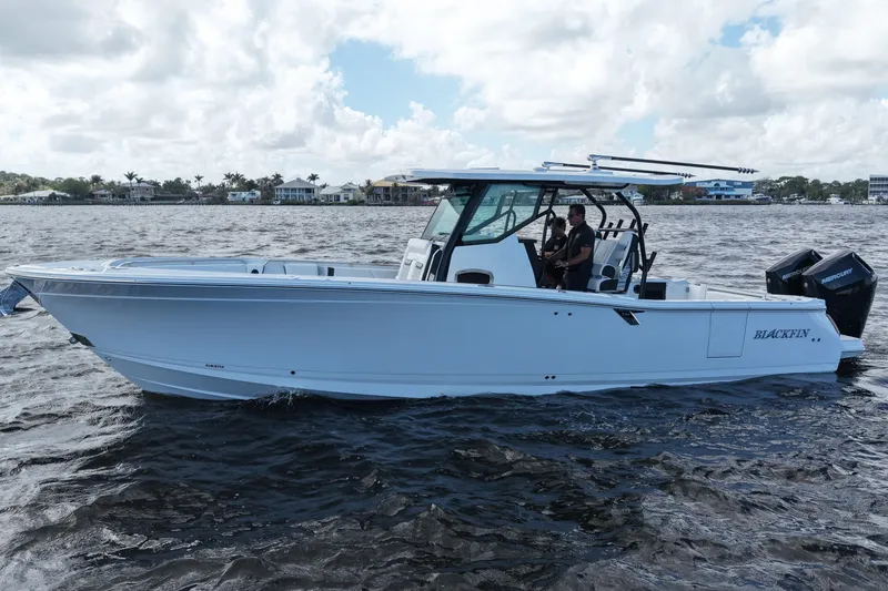 Slide: The Image of 2026 Blackfin 332 CC boat cruising on a sunny day with calm waters. - 14