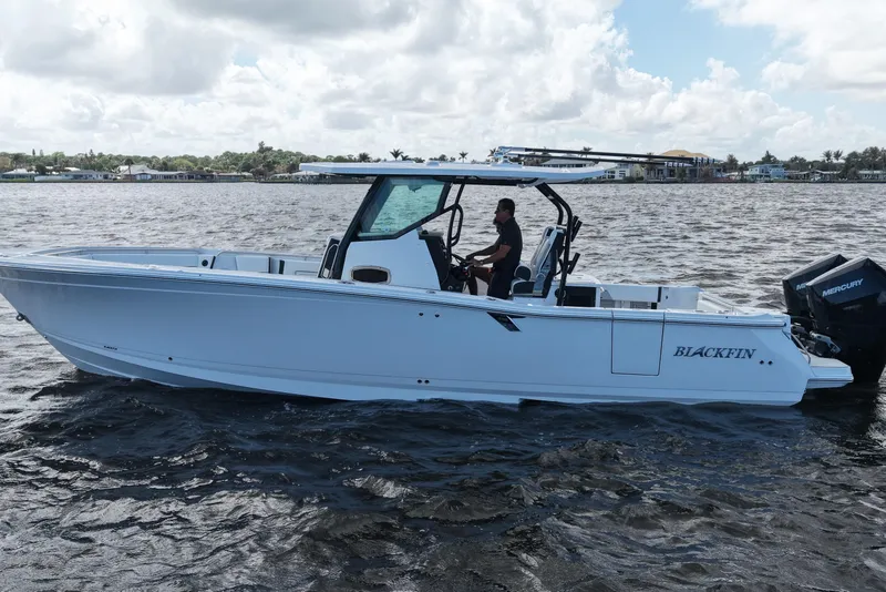 Slide: The Image of 2026 Blackfin 332 CC boat cruising on a sunny day with a person at the helm. - 15