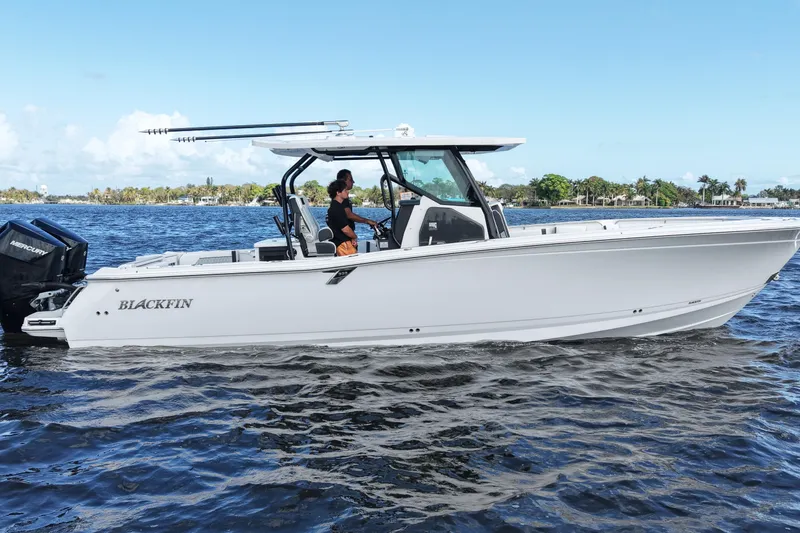 Slide: The Image of 2026 Blackfin 332 CC boat cruising on a sunny day with clear blue skies. - 17