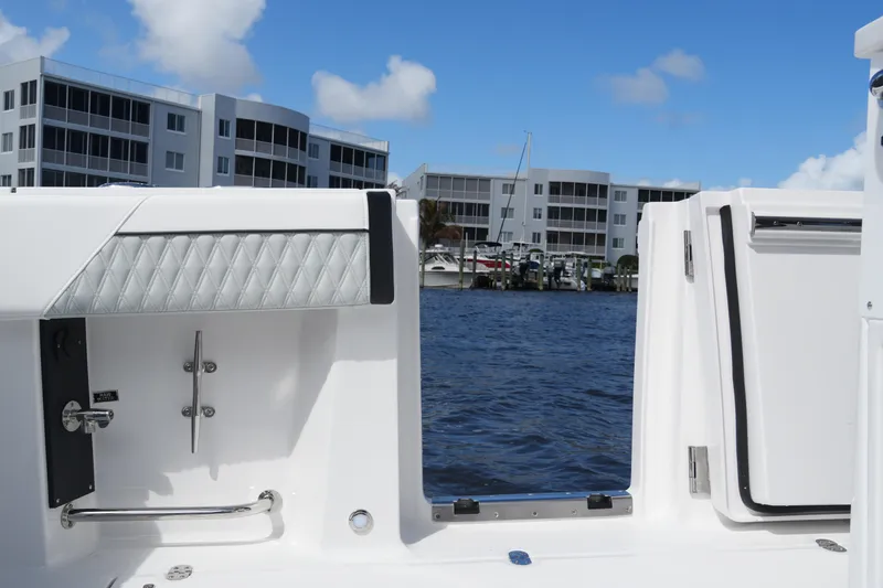 Slide: The Image of 2026 Blackfin 332 CC boat interior with waterfront view and modern buildings. - 18