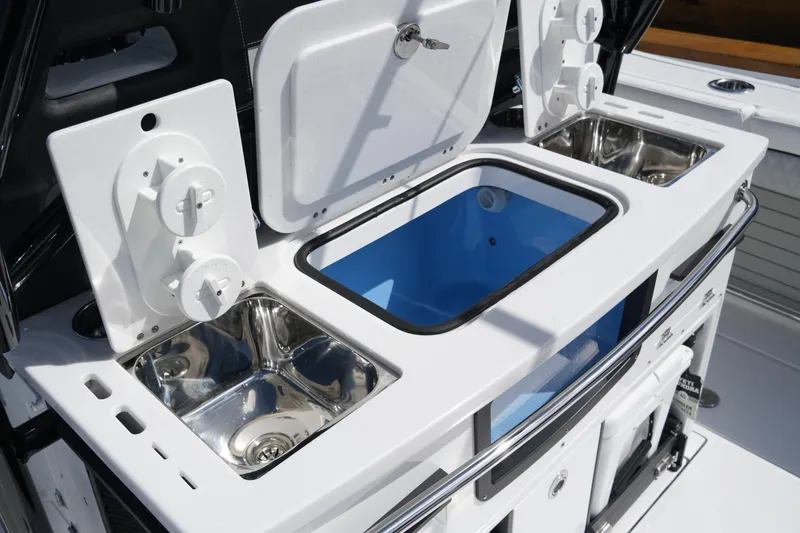 Slide: The Image of 2026 Blackfin 332 CC boat with dual sinks and storage compartments. - 21