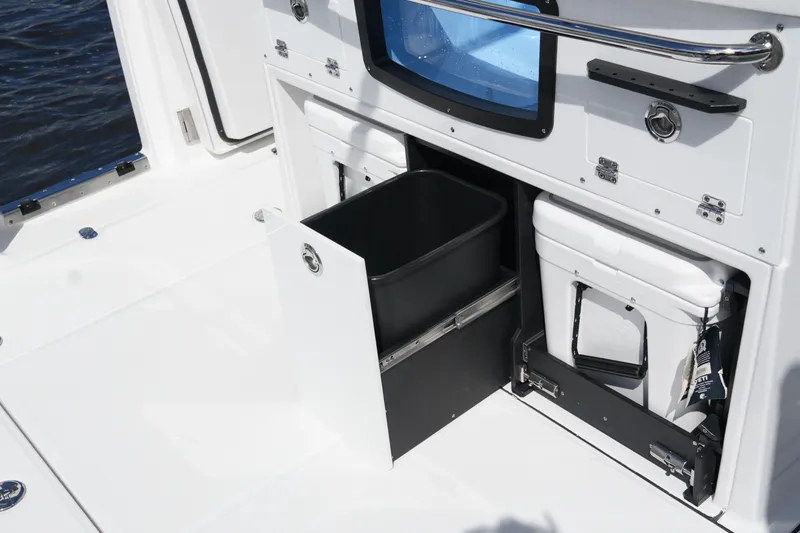 Slide: The Image of 2026 Blackfin 332 CC boat interior with storage compartments and cooler. - 22