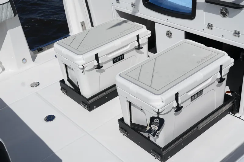 Slide: The Image of 2026 Blackfin 332 CC boat with Yeti coolers on deck. - 23