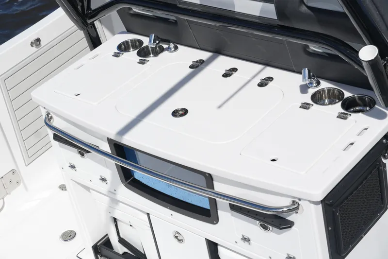 Slide: The Image of 2026 Blackfin 332 CC boat console with cup holders and storage compartments. - 24