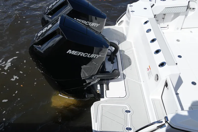 Slide: The Image of 2026 Blackfin 332 CC boat with dual Mercury outboard engines on water. - 25