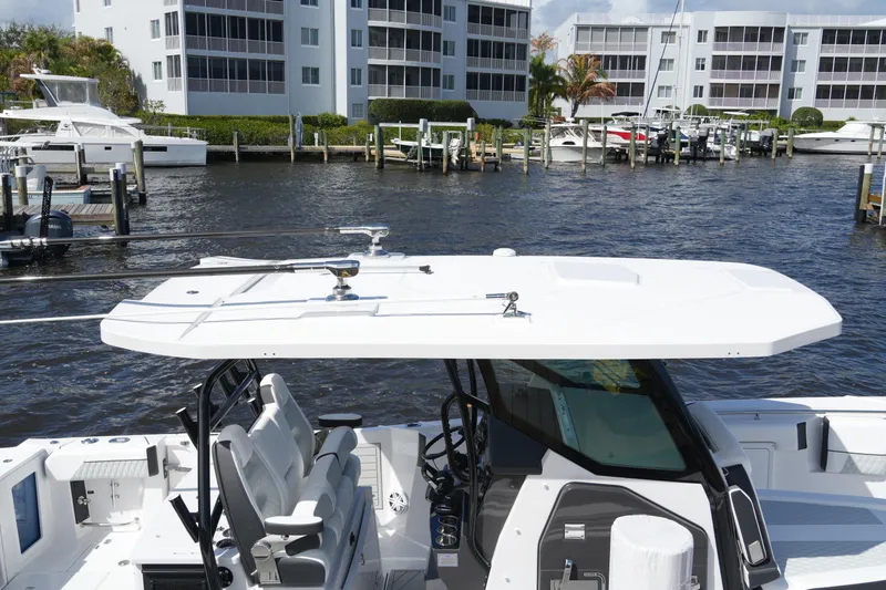 Slide: The Image of 2026 Blackfin 332 CC boat docked near waterfront buildings. - 27