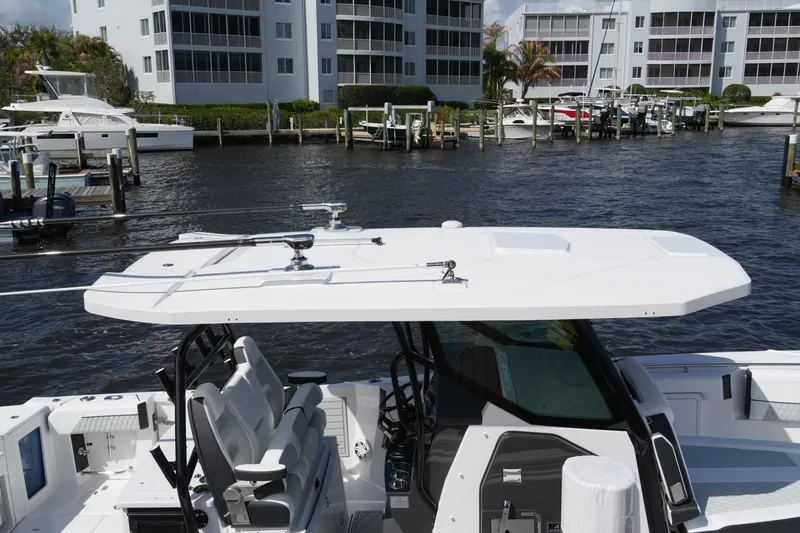 Slide: The Image of 2026 Blackfin 332 CC boat docked near waterfront buildings. - 28