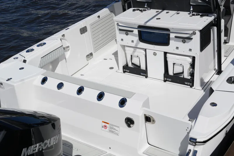 Slide: The Image of 2026 Blackfin 332 CC boat deck with storage and seating, featuring Mercury engine. - 35