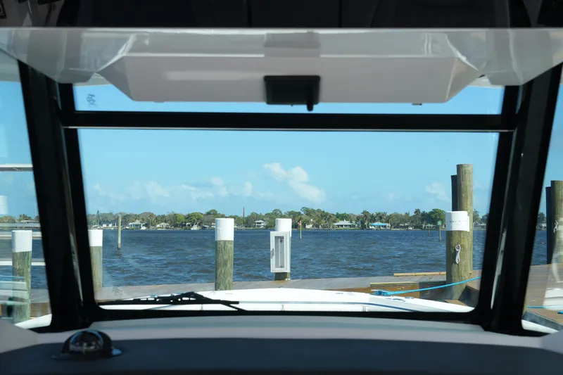 Slide: The Image of View from 2026 Blackfin 332 CC boat cockpit overlooking marina and calm waters. - 37