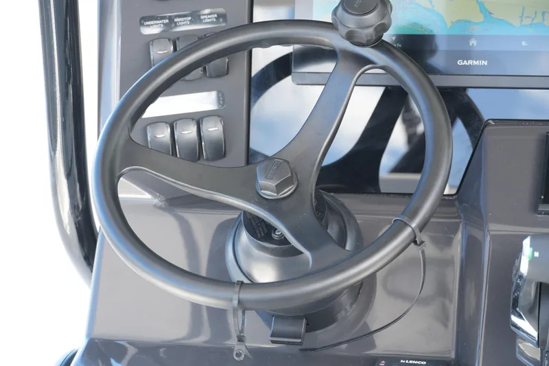 Slide: The Image of Steering wheel of 2026 Blackfin 332 CC boat with control panel and Garmin display. - 39