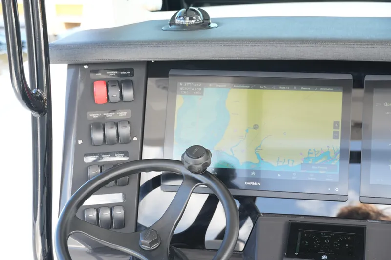 Slide: The Image of 2026 Blackfin 332 CC boat dashboard with Garmin navigation display and control panel. - 42