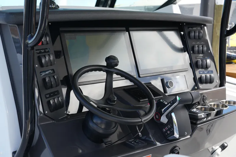 Slide: The Image of 2026 Blackfin 332 CC boat dashboard with advanced controls and dual screens. - 43