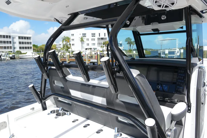Slide: The Image of 2026 Blackfin 332 CC boat interior with rod holders and modern dashboard. - 46