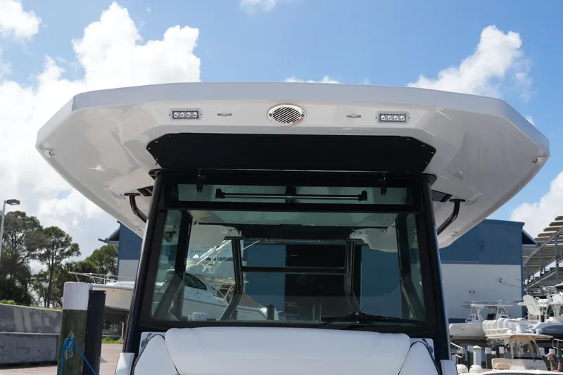 Slide: The Image of 2026 Blackfin 332 CC boat front view with modern design and clear sky background. - 47