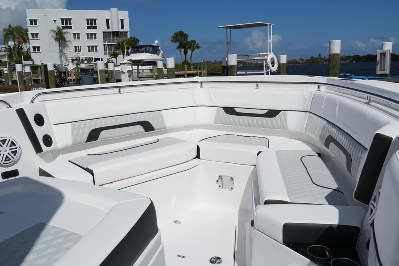 Slide: The Image of 2026 Blackfin 332 CC boat interior with luxurious seating and modern design at a marina. - 50