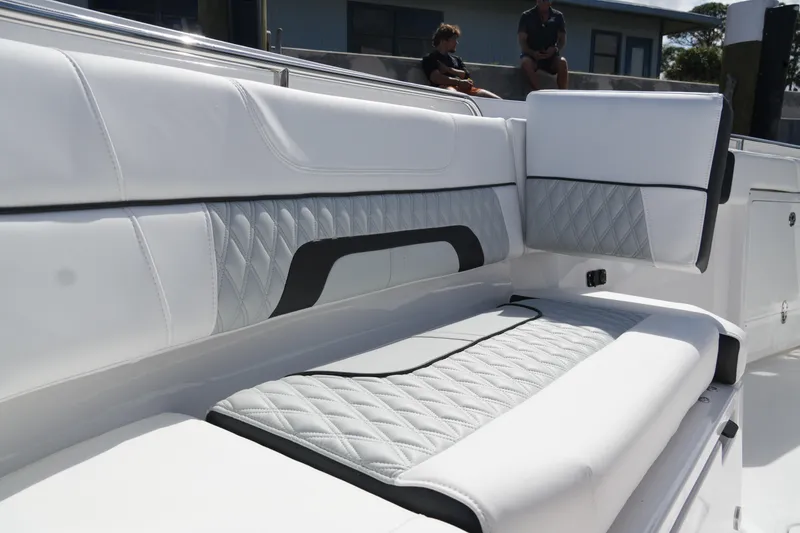 Slide: The Image of 2026 Blackfin 332 CC boat with luxurious white and gray seating. - 52