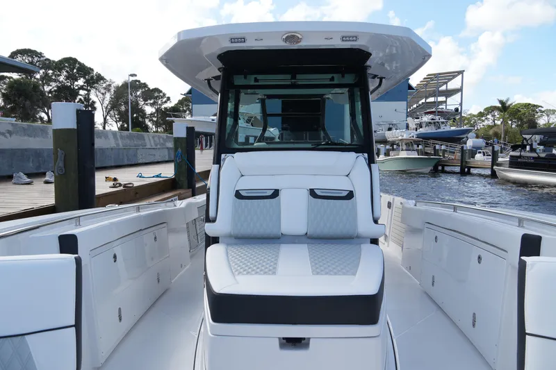 Slide: The Image of 2026 Blackfin 332 CC boat docked, showcasing sleek design and spacious seating. - 54