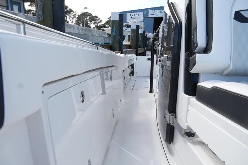 Slide: The Image of 2026 Blackfin 332 CC boat interior, showcasing sleek white seating and modern design. - 56