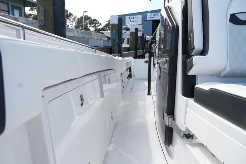 Slide: The Image of 2026 Blackfin 332 CC boat interior, showcasing sleek white seating and modern design. - 57