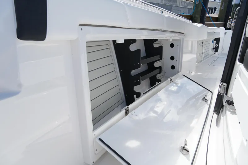 Slide: The Image of 2026 Blackfin 332 CC boat storage compartment with open hatch and sleek design. - 58