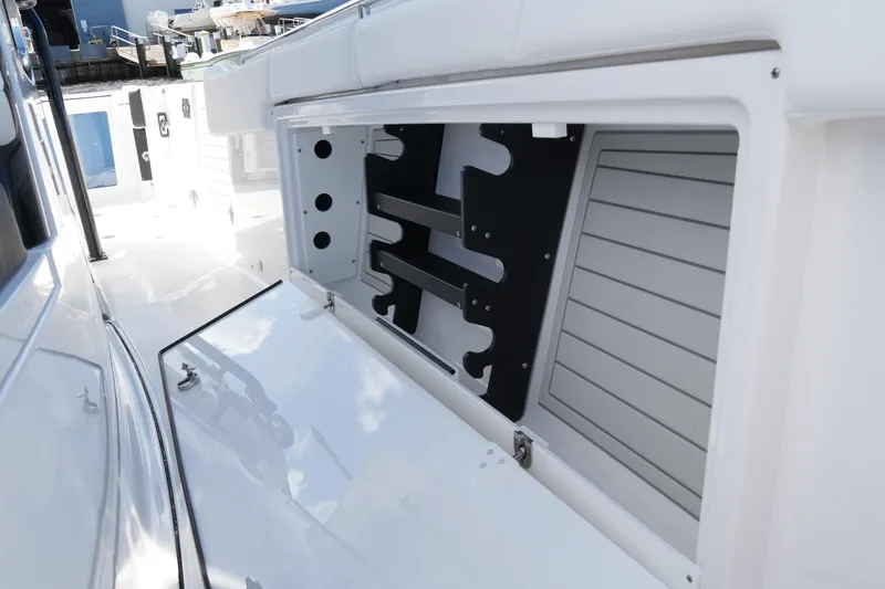 Slide: The Image of 2026 Blackfin 332 CC boat storage compartment with open hatch, showcasing interior design. - 59