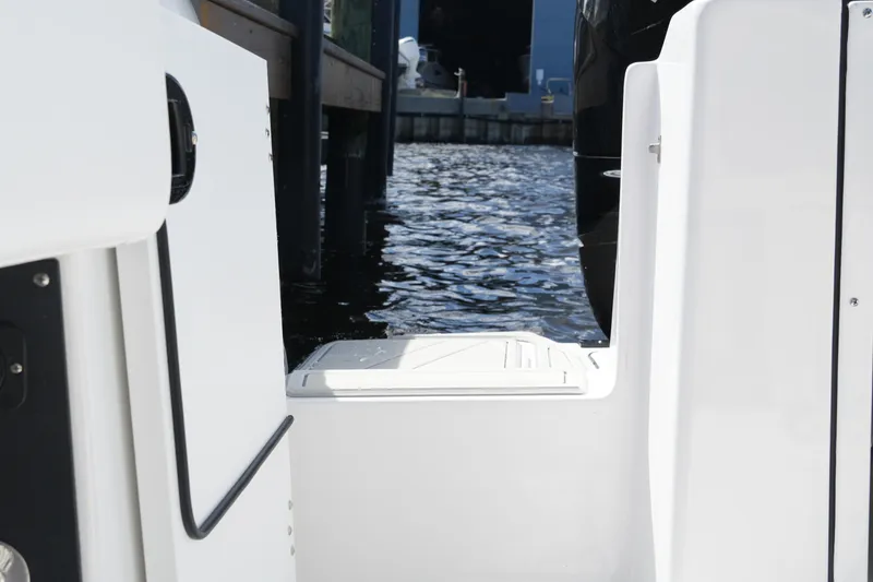 Slide: The Image of 2026 Blackfin 332 CC boat stern view with water backdrop. - 69