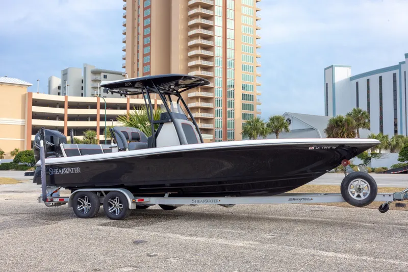 The Image of 2018 ShearWater 26 Carolina boat on trailer, urban background, side view. - 0