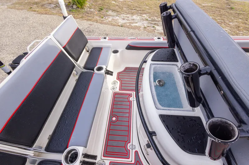 Slide: The Image of 2018 ShearWater 26 Carolina boat interior with seating and rod holders. - 14