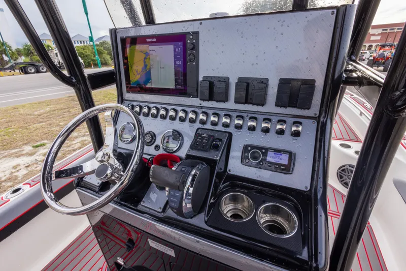 Slide: The Image of 2018 ShearWater 26 Carolina boat dashboard with navigation system and controls. - 16