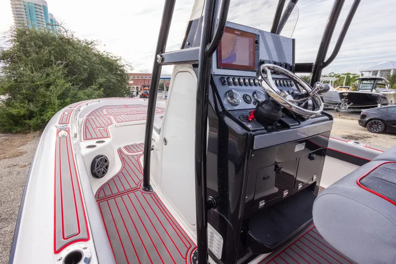 Slide: The Image of 2018 ShearWater 26 Carolina boat interior with modern dashboard and steering wheel. - 19