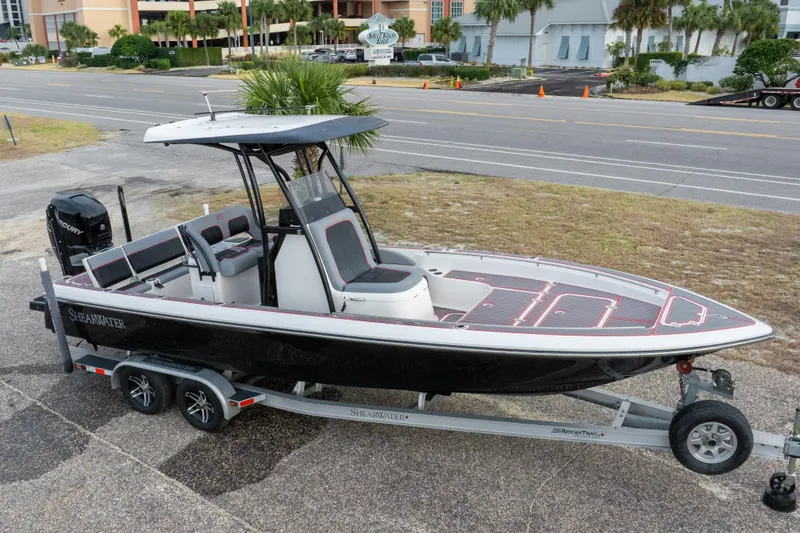 Slide: The Image of 2018 ShearWater 26 Carolina boat on trailer, parked near a road. - 31