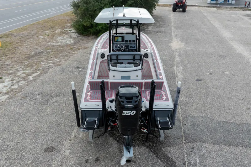 Slide: The Image of 2018 ShearWater 26 Carolina boat with powerful 350 outboard engine, parked on pavement. - 34