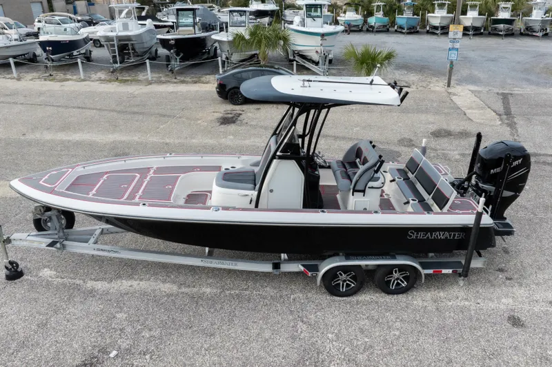 Slide: The Image of 2018 ShearWater 26 Carolina boat on trailer, parked in marina lot. - 36