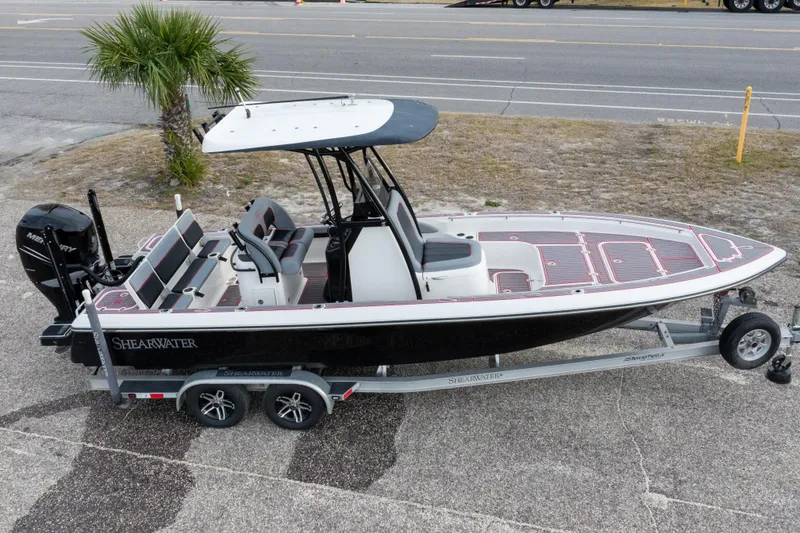 Slide: The Image of 2018 ShearWater 26 Carolina boat on trailer, parked near a road. - 40