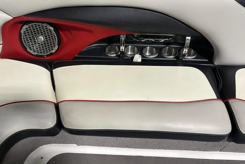 Slide: The Image of 2015 Malibu Wakesetter 247 LSV interior with speaker, cup holders, and cushioned seating. - 12