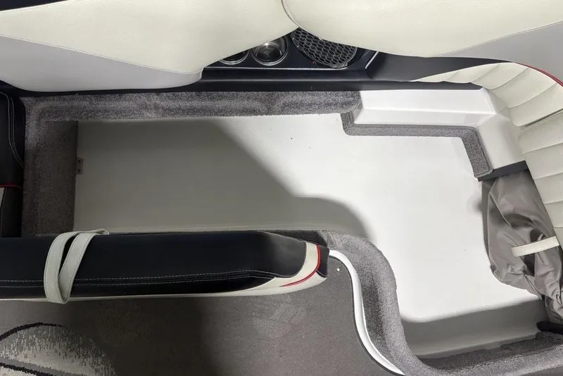 Slide: The Image of Interior of 2015 Malibu Wakesetter 247 LSV boat, featuring seating and carpeted flooring. - 13