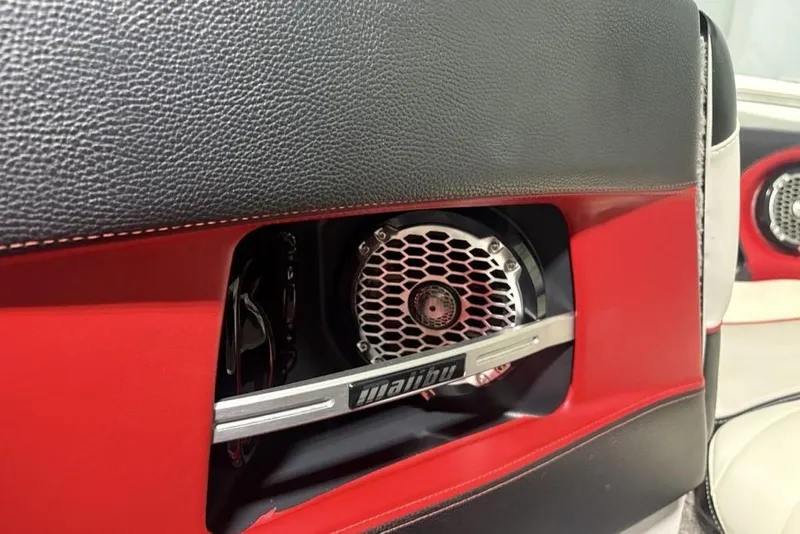 Slide: The Image of 2015 Malibu Wakesetter 247 LSV interior speaker detail with red and black accents. - 3