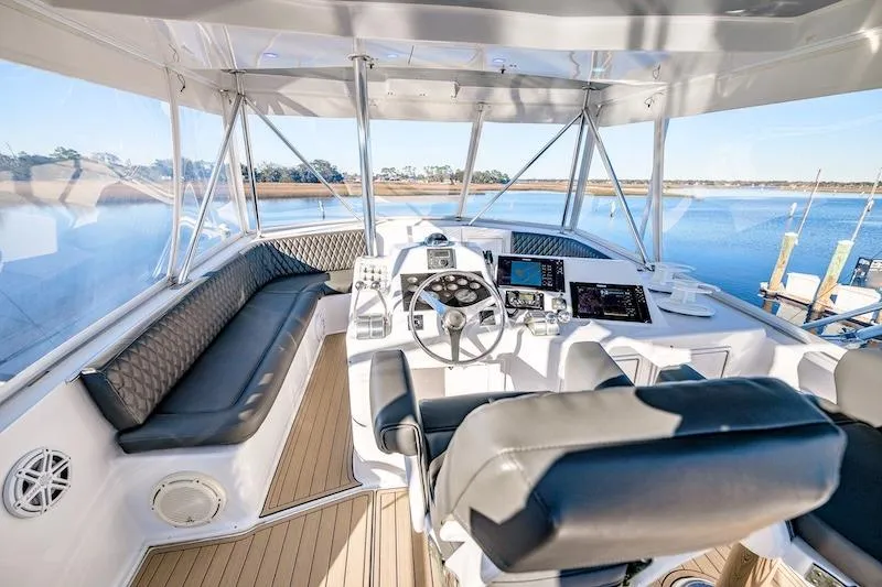 Slide: The Image of Luxurious 1991 Ocean Yachts 53 Super Sport cockpit with modern controls and panoramic views. - 12