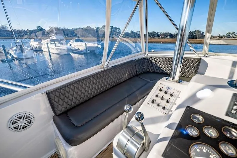 Slide: The Image of Interior view of 1991 Ocean Yachts 53 Super Sport, featuring helm and seating area. - 16